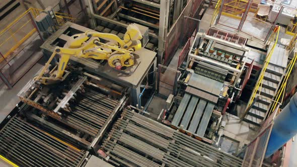 Top View of a Robotic Arm Preparing To Relocate Bricks. Modern Automated Factory Equipment. alt