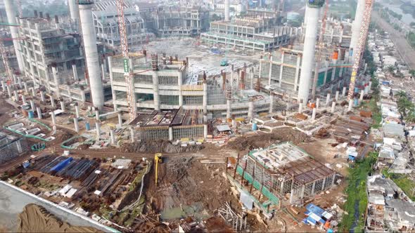 Foggy aerial view of the construction of a football stadium alt