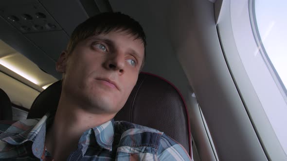 Young Man In Plane Cabin alt