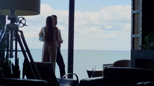 Sensual Couple Enjoying Ocean View at Hotel alt