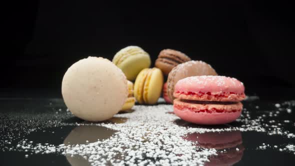 Colored Macaroons Confectionery Marshmallows on a Black Reflective Background in Perspective