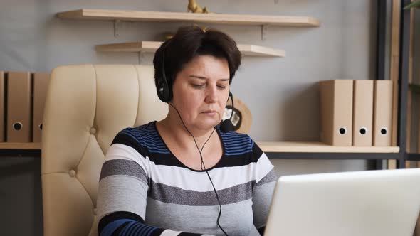 Old Woman Wearing Headset, Holding Video Call Support Services with Customer alt