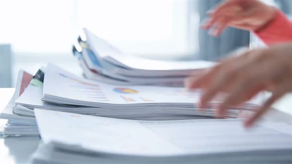 Businesswoman Accountant Sorting  Stack Of Documents alt