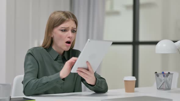 Disappointed Woman Reacting to Loss on Tablet alt