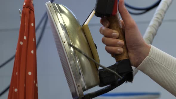 Woman Worker's Hand Ironing Skirt in Dry Cleaning alt