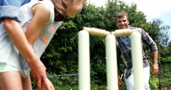 Happy family playing cricket alt