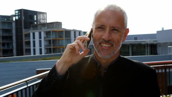 Businessman talking on mobile phone in hotel balcony 4k alt