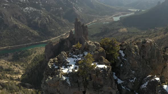 Aerial shot flying over mountains near Bariloche and revealing an incredible river valley in Patagon alt