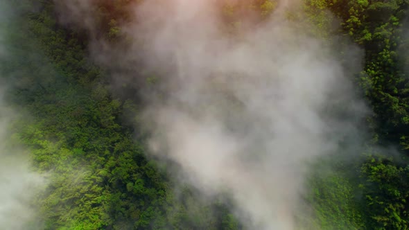 Aerial view from a drone over mountain fog during sunrise alt