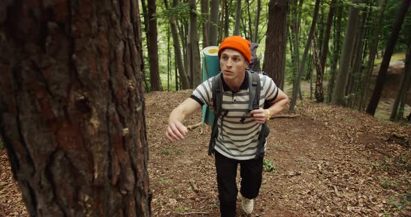 Male Tourist Going Uphill in Forest