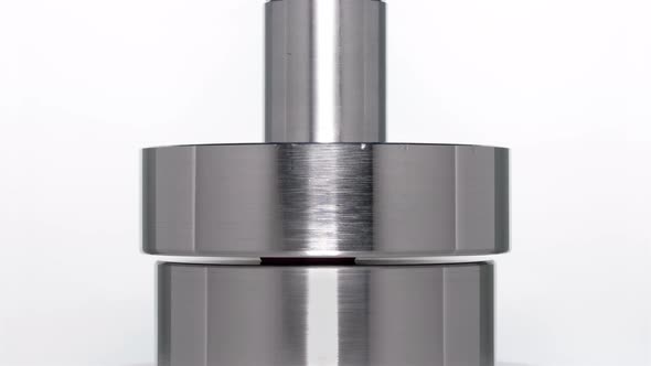 the Appearance of the Letter G When Lifting a Rod From a Hydraulic Press on a White Background alt