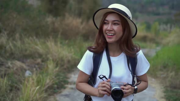 woman with backpack walking on footpath in nature at Wang Nam Khiao, Thailand alt