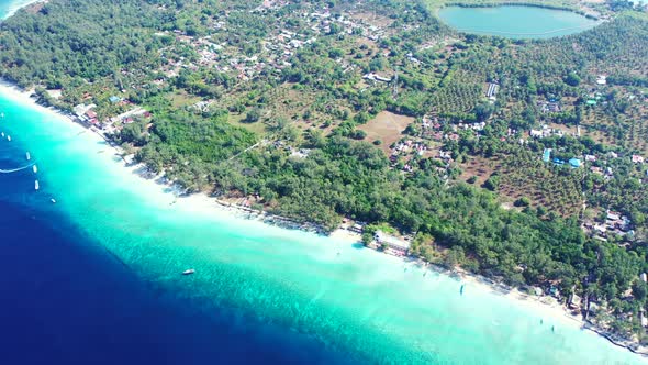 Deep blue sea next to turquoise shallow lagoon around tropical island in Gili meno, Indonesia with w alt