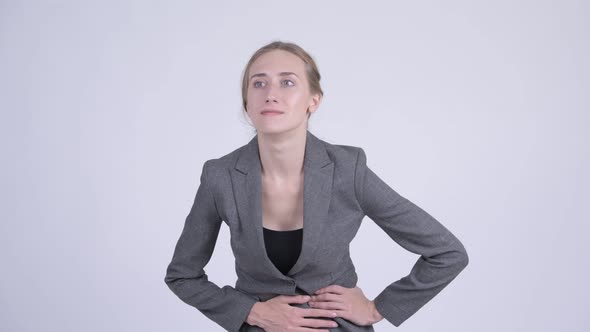 Young Stressed Blonde Businesswoman Having Stomach Ache alt
