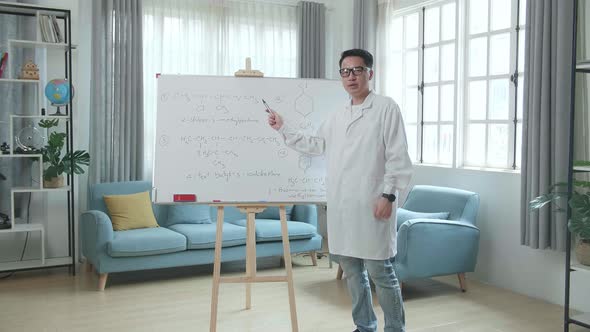 Asian Male Teacher With Glasses Teaching Chemist At Home alt