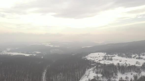 Cloudy sky and rays of sun over the valley 4K drone video alt