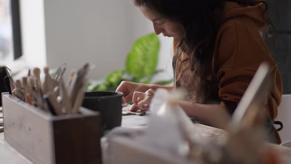 Professional Potter Woman Working on Details of a Clay Handcraft Piece alt