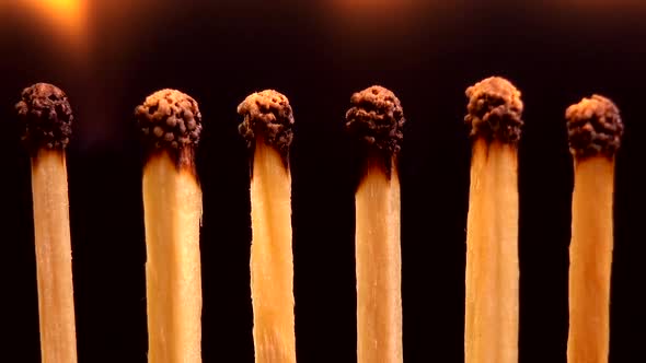 Burning matches on a black background. alt