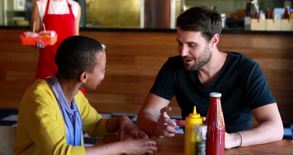 Waitress serving food to customers alt