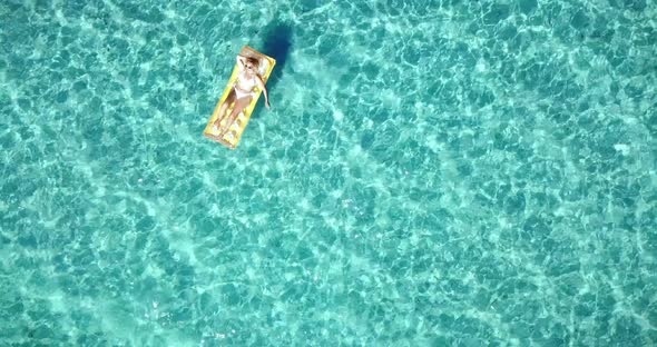 Happy tourist woman enjoy colorful mattress lilo in transparent amazing sea water alt