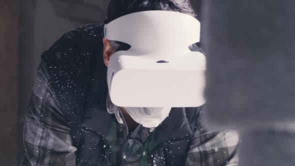 Craftsman in VR Goggles Working in Workshop alt