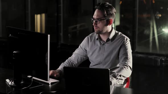 Programmer Man Is Working in the Office Late at Night Overtime alt