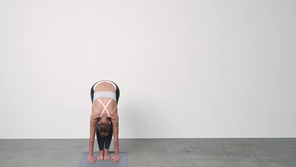 Woman Performing Yoga Against Wall