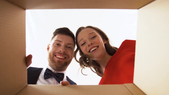 Happy Couple Opening Christmas Gift Box  alt