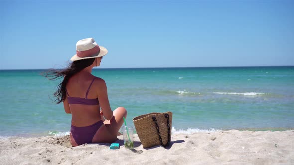 Young Woman in Hat on the Beach Vacation