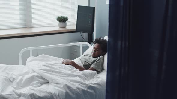 Sick Boy Sleeping in Hospital Bed alt