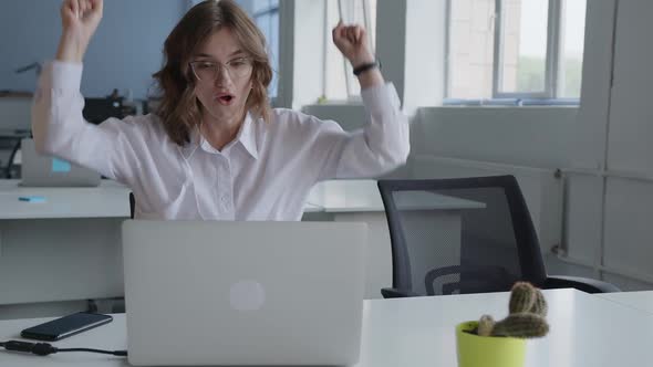 Young Lady Glad That She Done Perfect Work on the Laptop alt