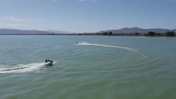 Pair of Two People Having Fun Riding Jet Ski Sea Doos on Utah Lake, Aerial alt