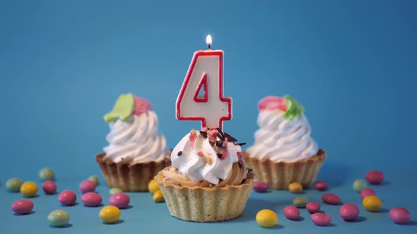 Happy Birthday Greetings to 4 Year Old Child Birthday Cupcake with Candle and Birthday Decorations alt