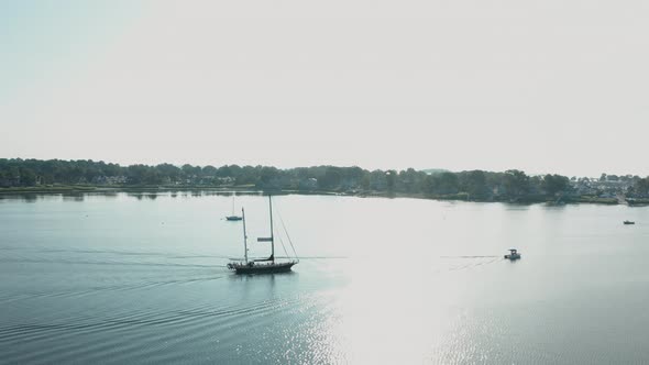 Aerial Drone Shot Tracking a Large Sailboat in a Quiet Harbor (Norwalk, Connecticut)