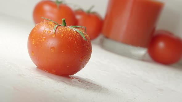 A Drops Flows Down From A Ripe Tomato. Fresh Juice On A Background