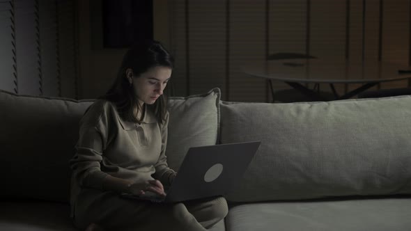 Female works online at night.