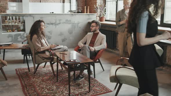 Business Partners Discussing Contract in Modern Coworking Office alt