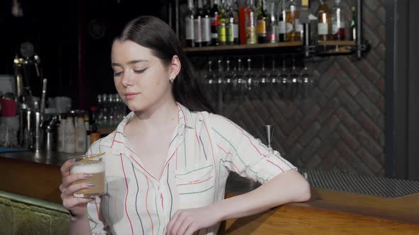 Charming Woman Toasting with Her Cocktail Glass To the Camera alt