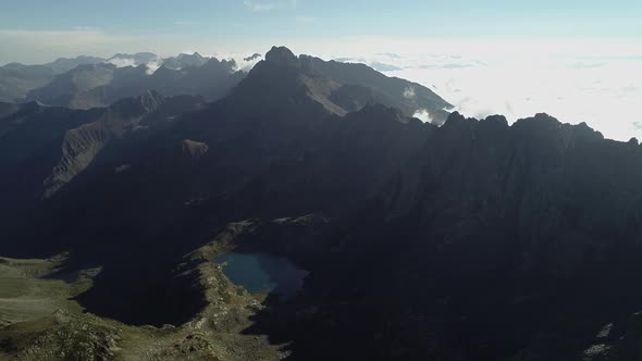 High Mountains from High Altitude Lake and Sea of Clouds