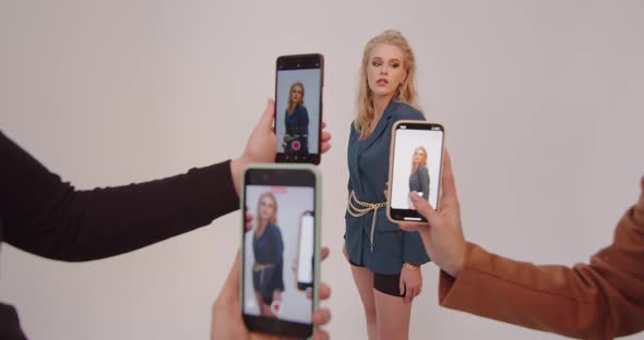 Model In The Studio Taking Pictures On Phones