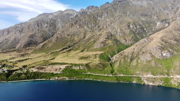 Winding road around Lake Wakatipu, high mountain scenery, New Zealand landscape alt