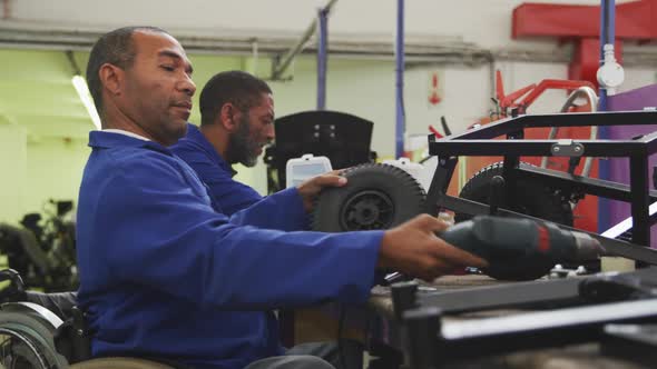 Mechanics assembling the wheels with an object alt