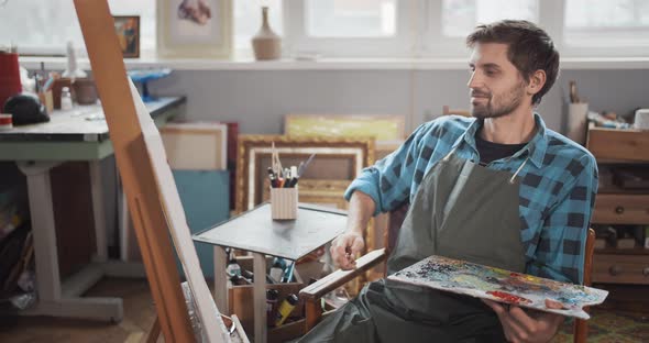 Bearded Male Artist Painting in Studio