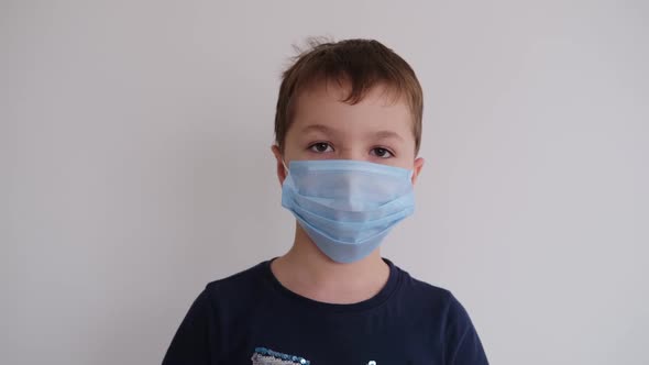 Little Boy Takes Off His Protective Medical Mask