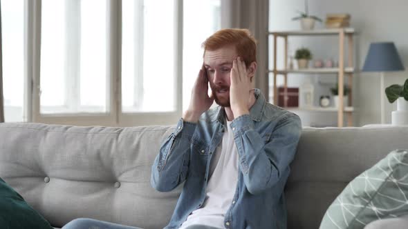 Creative Beard Man with Headache Sitting in Creative Room alt