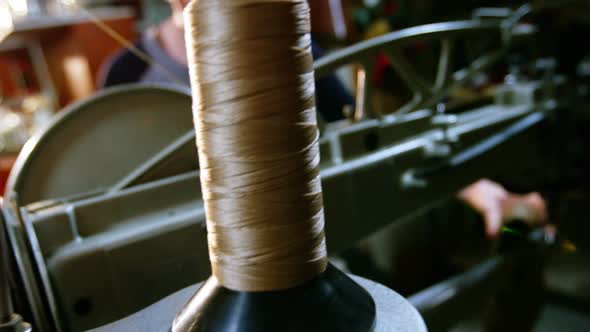 Shoemaker examining a shoe alt