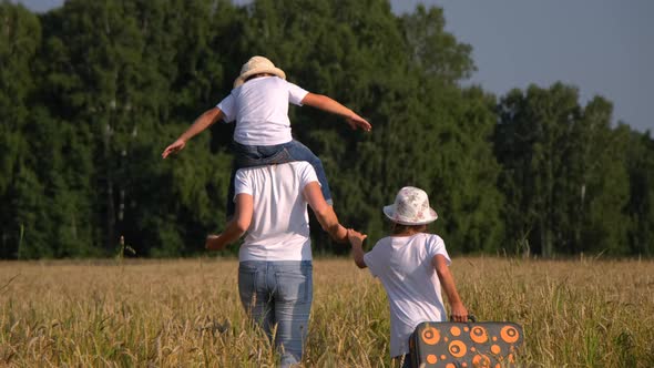 Mother with Children Walking Through Wheat Field alt