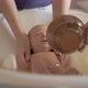 Mum and grandma bathing baby - VideoHive Item for Sale
