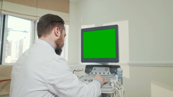 Doctor Operating Ultrasound Scanner with Green Screen alt