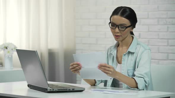 Woman Typing on Laptop at Home, Paying for Utilities or Checking Correspondence alt